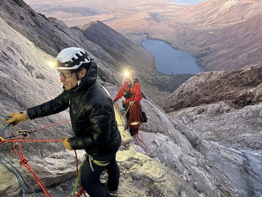 This photo released by the Mono County Search and Rescue shows volunteers conducting an operation to rescue a man stranded on a ledge in the Sierra Nevada, Calif., on Aug. 22, 2026. (Mono County Sheriff Search and Rescue via AP)