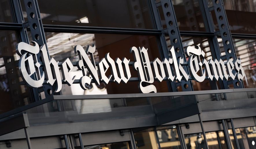 FILE - A sign for The New York Times hangs above the entrance to its building in New York, May 6, 2021. (AP Photo/Mark Lennihan, File)