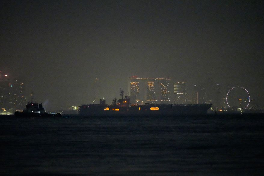 The U.S. Navy aircraft carrier USS Abraham Lincoln sails past Singapore as seen from Batam, Indonesia, Sunday, Aug. 30, 2026. (AP Photo/Dita Alangkara)