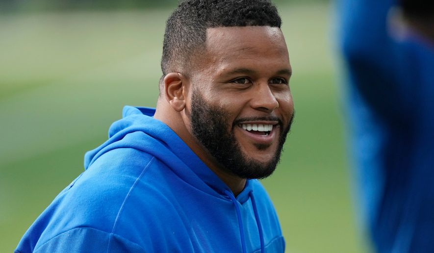 FILE - Los Angeles Rams defensive tackle Aaron Donald warms up before an NFL football game against the Cleveland Browns, Dec. 3, 2023, in Inglewood, Calif. (AP Photo/Mark J. Terrill, File)