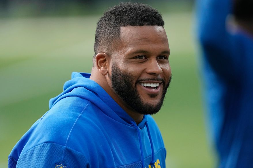 FILE - Los Angeles Rams defensive tackle Aaron Donald warms up before an NFL football game against the Cleveland Browns, Dec. 3, 2023, in Inglewood, Calif. (AP Photo/Mark J. Terrill, File)