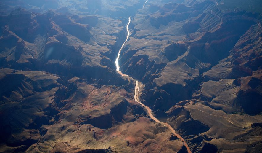Bright Angel Canyon, middle left, the scene of flash floods, meets with the Colorado River in the Grand Canyon, Monday, Aug. 31, 2026, at Grand Canyon National Park, Ariz. (AP Photo/John Locher)