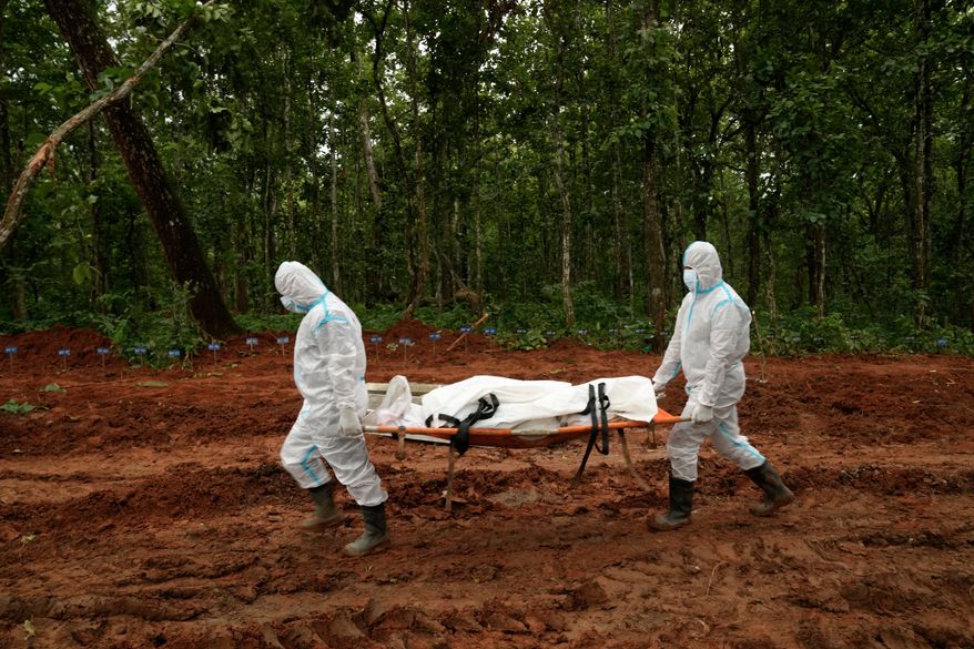Nepal's paramilitary force personnel carry the body of a flash flood victim for burial at a mass burial site in Chitwan, Nepal, Monday, Aug. 31, 2026. (AP Photo/Dar Yasin)