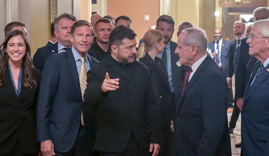 Ukraine's President Volodymyr Zelenskyy, center, is joined by from left: Sen. Katie Britt, R-Ala., Sen. Richard Blumenthal, D-Conn., Sen. James Risch, R-Idaho, and Sen. Roger Wicker, R-Miss., as he arrives at the U.S. Capitol for a meeting of bipartisan leaders of the Lindsey O. Graham Sanctioning Russia and Iran Act of 2026, July 28, 2026, in Washington. (AP Photo/Rod Lamkey, Jr., File)