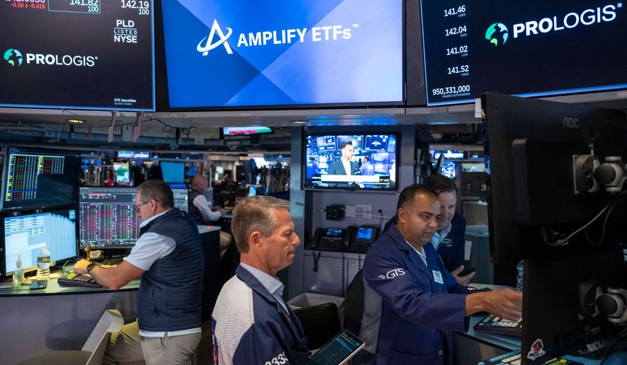 Specialists Dilip Patel, right, and Trader Robert Charmak, center, work on the floor of the New York Stock Exchange, Thursday, Aug. 27, 2026, in New York. (AP Photo/Yuki Iwamura)