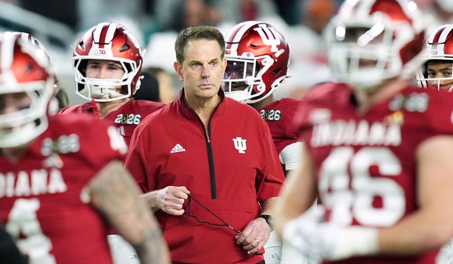 FILE - Indiana head coach Curt Cignetti watches during warm ups before the College Football Playoff national championship game between Miami and Indiana, Monday, Jan. 19, 2026, in Miami Gardens, Fla. (AP Photo/Rebecca Blackwell, File)