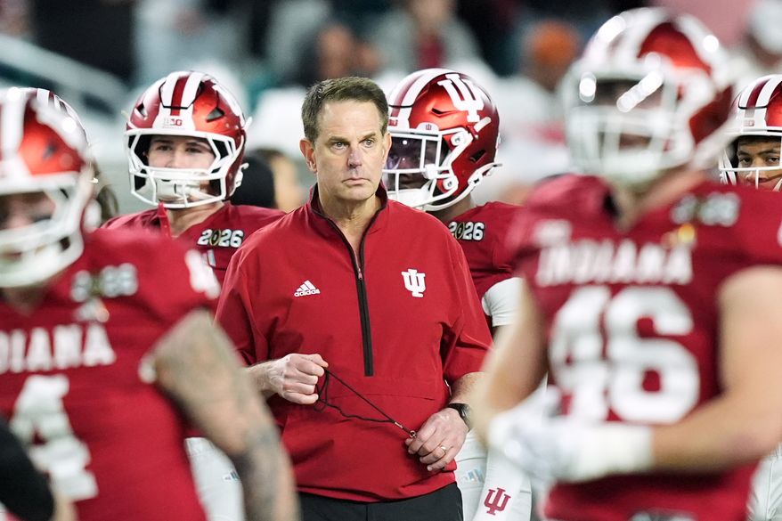 FILE - Indiana head coach Curt Cignetti watches during warm ups before the College Football Playoff national championship game between Miami and Indiana, Monday, Jan. 19, 2026, in Miami Gardens, Fla. (AP Photo/Rebecca Blackwell, File)