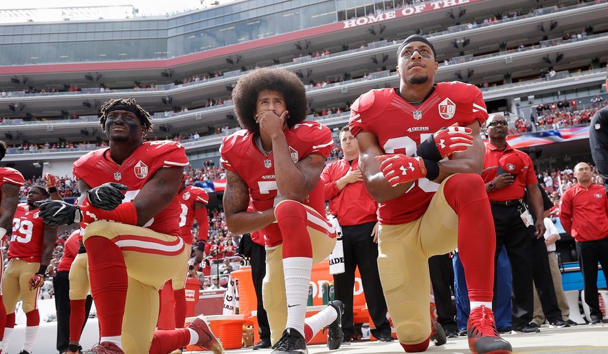 FILE - In this Oct. 2, 2016, file photo, from left, San Francisco 49ers outside linebacker Eli Harold, quarterback Colin Kaepernick and safety Eric Reid kneel during the national anthem before an NFL football game against the Dallas Cowboys in Santa Clara, Calif. (AP Photo/Marcio Jose Sanchez, File)