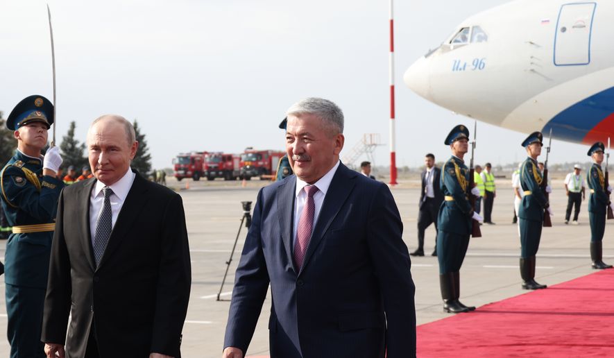 Russian President Vladimir Putin, left, is greeted by The Chairman of the Cabinet of Ministers of Kyrgyzstan Adylbek Kasymaliev upon his arrival for the Shanghai Cooperation Organization (SCO) Summit in Bishkek, Kyrgyzstan, Monday, Aug. 31, 2026. (Konstantin Zavrazhin, Sputnik, Kremlin Pool Photo via AP)