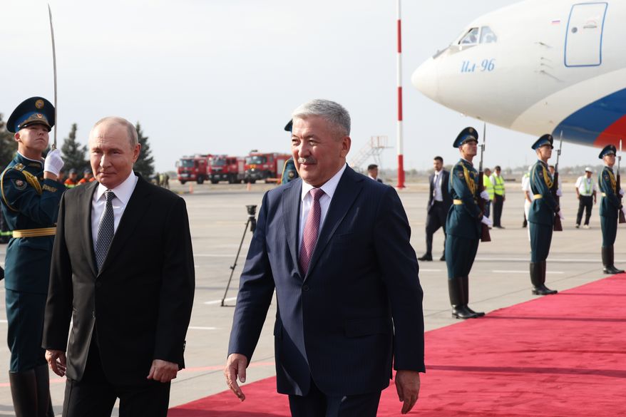 Russian President Vladimir Putin, left, is greeted by The Chairman of the Cabinet of Ministers of Kyrgyzstan Adylbek Kasymaliev upon his arrival for the Shanghai Cooperation Organization (SCO) Summit in Bishkek, Kyrgyzstan, Monday, Aug. 31, 2026. (Konstantin Zavrazhin, Sputnik, Kremlin Pool Photo via AP)