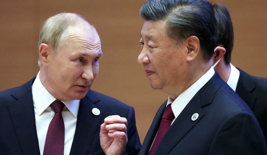 Russian President Vladimir Putin, left, gestures while speaking to Chinese President Xi Jinping during the Shanghai Cooperation Organization (SCO) summit in Samarkand, Uzbekistan, Sept. 16, 2022. (Sergei Bobylev, Sputnik, Kremlin Pool Photo via AP, File)