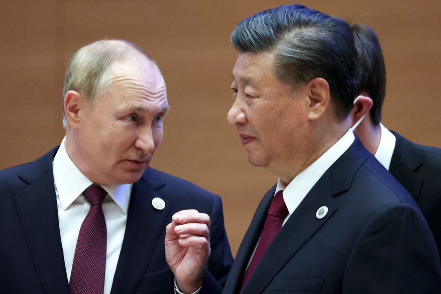 Russian President Vladimir Putin, left, gestures while speaking to Chinese President Xi Jinping during the Shanghai Cooperation Organization (SCO) summit in Samarkand, Uzbekistan, Sept. 16, 2022. (Sergei Bobylev, Sputnik, Kremlin Pool Photo via AP, File)
