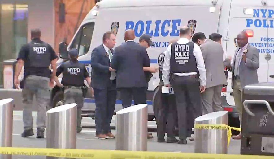 This image made from video provided by WABC shows NYPD officers on the scene after a woman brandishing two large knives was shot by officers in Times Square in New York, Monday, Aug. 31, 2026. (WABC via AP)