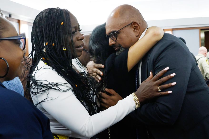 Friends and family members of rapper Tupac Shakur, including his sister Sekyiwa Shakur, second left, line up to hug Chief Deputy District Attorney Binu Palal, right, after a jury found Duane Davis guilty of first-degree murder in his trial related to the 1996 killing of rapper Tupac Shakur, at Clark County District Court Regional Justice Center, Monday, Aug. 31, 2026, in Las Vegas. (Bizuayehu Tesfaye/Las Vegas Review-Journal via AP, Pool)