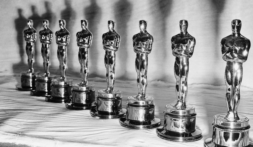 FILE - Oscar statuettes stand in a row, ready for the the presentation of the 22nd annual Academy Awards, in Los Angeles, March 9, 1950. (AP Photo, File)