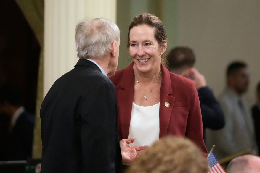 Assemblymember Jacqui Irwin, right, talks with Assemblymember Steve Bennett during an Assembly session at the Capitol, Monday, Aug. 31, 2026, in Sacramento, Calif. (AP Photo/Jeff Chiu)