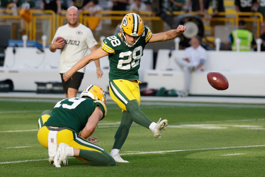 Green Bay Packers place kicker Trey Smack kicks with Daniel Whelan holding a preseason NFL football game against the Arizona Cardinals Friday, Aug. 28, 2026, in Green Bay, Wis. (AP Photo/Matt Ludtke)