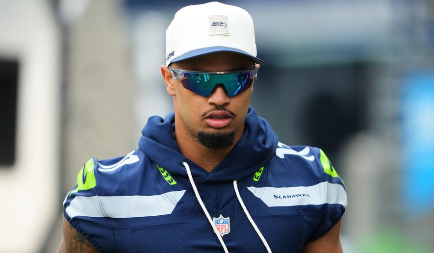 Seattle Seahawks wide receiver Jaxon Smith-Njigba walks onto the field during the first half of an NFL preseason football game against the Dallas Cowboys, Saturday, Aug. 15, 2026, in Seattle. (AP Photo/Lindsey Wasson)