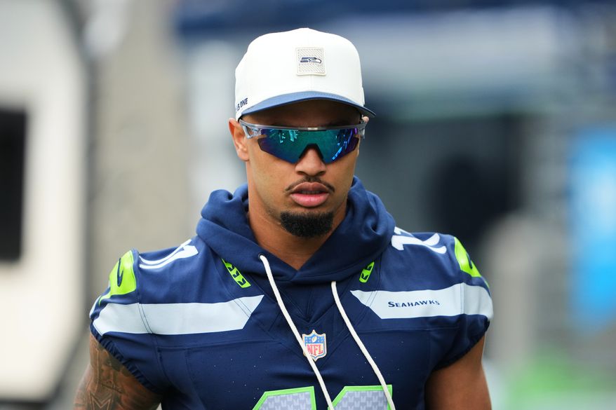 Seattle Seahawks wide receiver Jaxon Smith-Njigba walks onto the field during the first half of an NFL preseason football game against the Dallas Cowboys, Saturday, Aug. 15, 2026, in Seattle. (AP Photo/Lindsey Wasson)