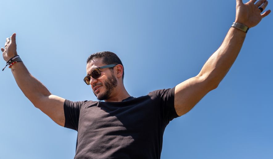 Abdul El-Sayed, a progressive candidate in the Democratic primary for U.S. Senate in Michigan, greets voters at Salina Intermediate School on election day, Tuesday, Aug. 4, 2026, in Dearborn, Mich. (AP Photo/Julia Demaree Nikhinson)