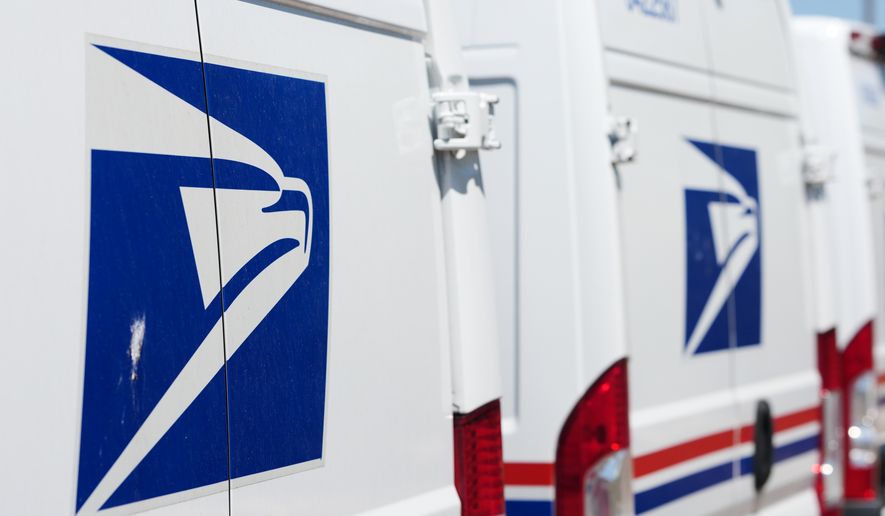 FILE - Delivery vans are parked during a protest staged as part of a countrywide National Day of Action Tuesday, July 28, 2026, outside the main United States Postal Service headquarters in northeast Denver. (AP Photo/David Zalubowski, File)