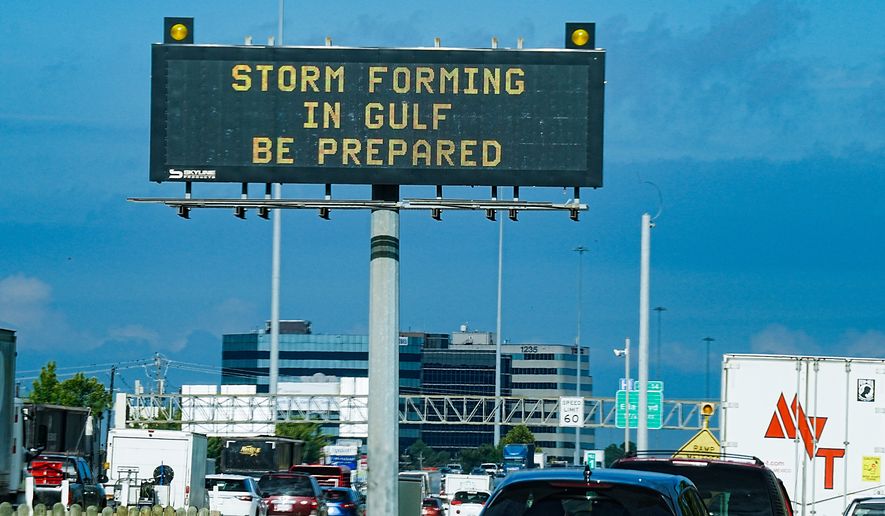 Motorists drive by Texas Department of Transportation signs on I-610 as Tropical Storm Edouard approaches in Houston, Tuesday, Sept. 1, 2026. (Elizabeth Conley/Houston Chronicle via AP)