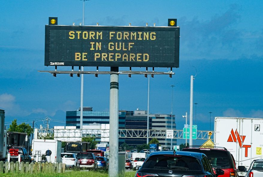 Motorists drive by Texas Department of Transportation signs on I-610 as Tropical Storm Edouard approaches in Houston, Tuesday, Sept. 1, 2026. (Elizabeth Conley/Houston Chronicle via AP)