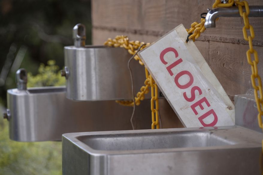 A sign is seen as officials at Grand Canyon National Park in northern Arizona have closed off access to water sources at the park after a flash flood damaged the only water pipeline that serves the canyon, Monday, Aug. 31, 2026. (AP Photo/Ty ONeil)