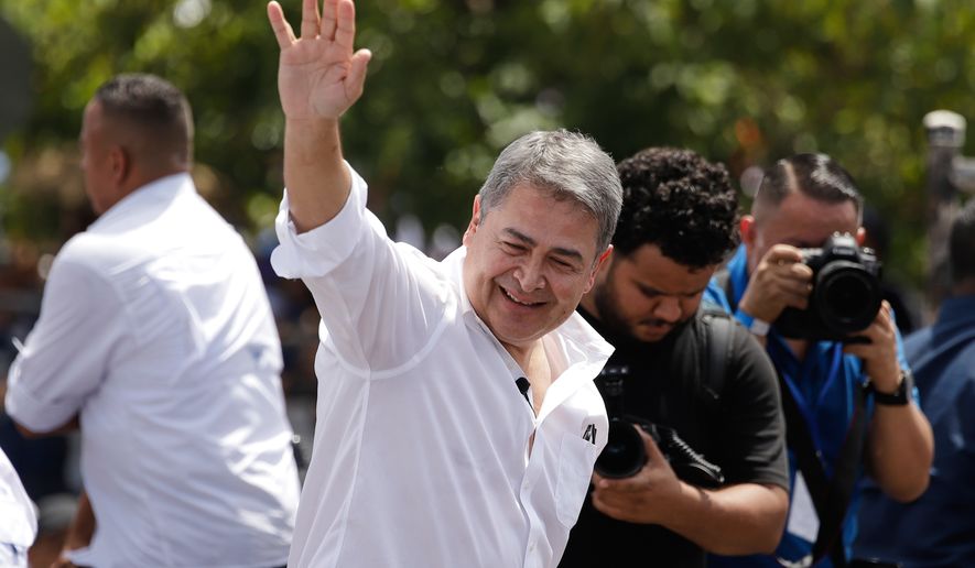 FILE - Former Honduran President Juan Orlando Hernández waves after his arrival to Toncontin airport in Tagucigalpa, Honduras, Sunday, July 26, 2026. (AP Photo/Fernando Destephen,File)