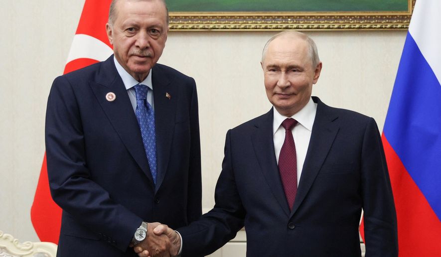 Russian President Vladimir Putin, right, and Turkish President Recep Tayyip Erdogan pose for a photo during their meeting on the sidelines of the Shanghai Cooperation Organization (SCO), in Bishkek, Kyrgyzstan, on Tuesday, Sept. 1, 2026. (Vyacheslav Prokofyev, Sputnik, Kremlin Pool Photo via AP)