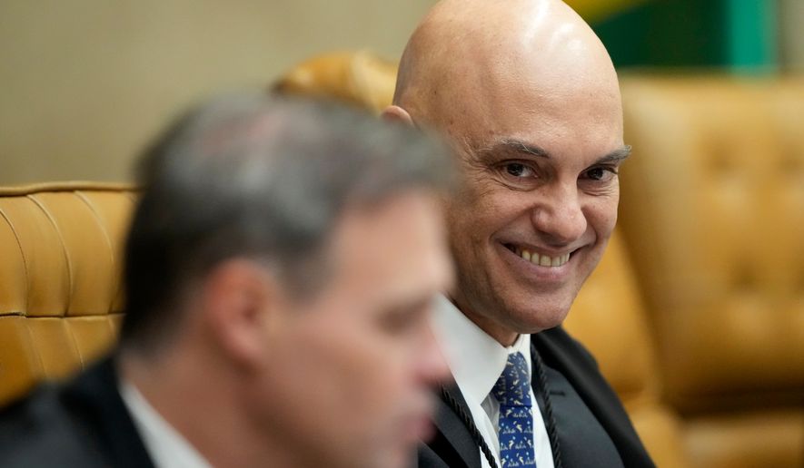 Supreme Court Justice Alexandre de Moraes smiles alongside Justice Andre Mendonca during a plenary session of the court in Brasilia, Brazil, Wednesday, Sept. 2, 2026. (AP Photo/Eraldo Peres)