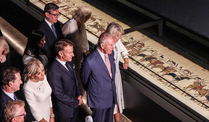 Britain's King Charles III and Queen Camilla, accompanied by The President of France Emmanuel Macron and Brigitte Macron, the Prime Minister, Andy Burnham and his wife Marie-France Van-Heel, view the Bayeux Tapestry Exhibition at the British Museum in London Wednesday, Sept. 2, 2026. (Richard Pohle, Pool Photo via AP)