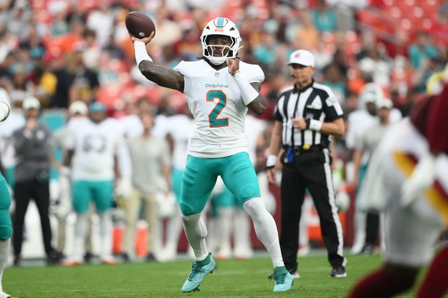 Miami Dolphins quarterback Malik Willis (2) aims a pass during the first half of an NFL preseason football game against the Washington Commanders, Friday, Aug. 14, 2026, in Landover, MD. (AP Photo/Nick Wass)