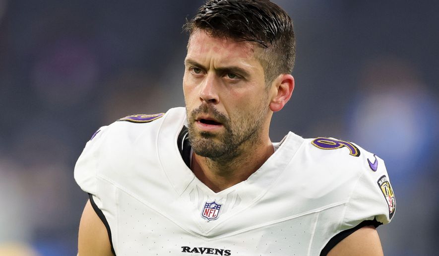 FILE - Baltimore Ravens place kicker Justin Tucker (9) walk on the field before an NFL football game against the Los Angeles Chargers, Nov. 25, 2024, in Inglewood, Calif. (AP Photo/Ryan Sun, FIle)