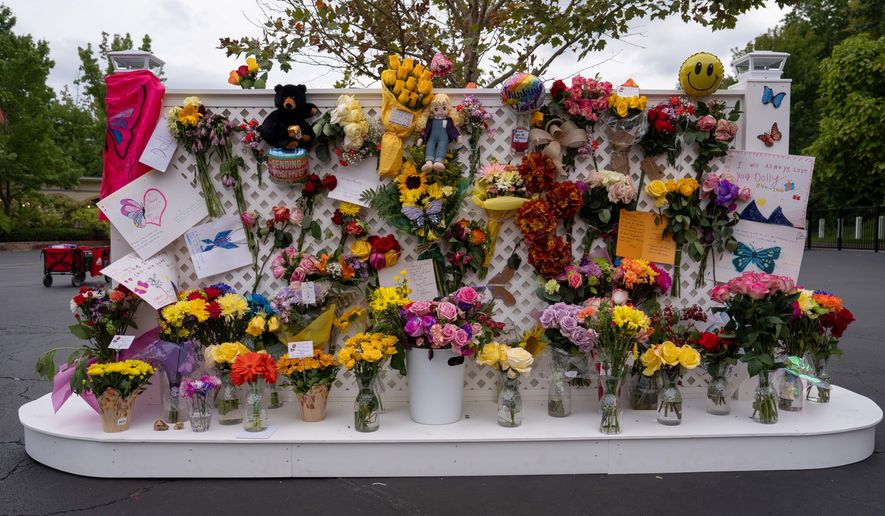 A memorial wall for Dolly Parton stands outside the Dollywood theme park in Pigeon Forge, Tenn., Wednesday, Aug. 26, 2026. (AP Photo/Camden Hall)