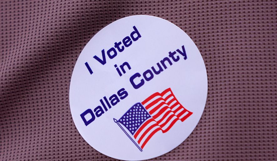A primary voter wears a sticker after casting a ballot at a voting center in Dallas, Tuesday, March 3, 2026. (AP Photo/LM Otero, File)