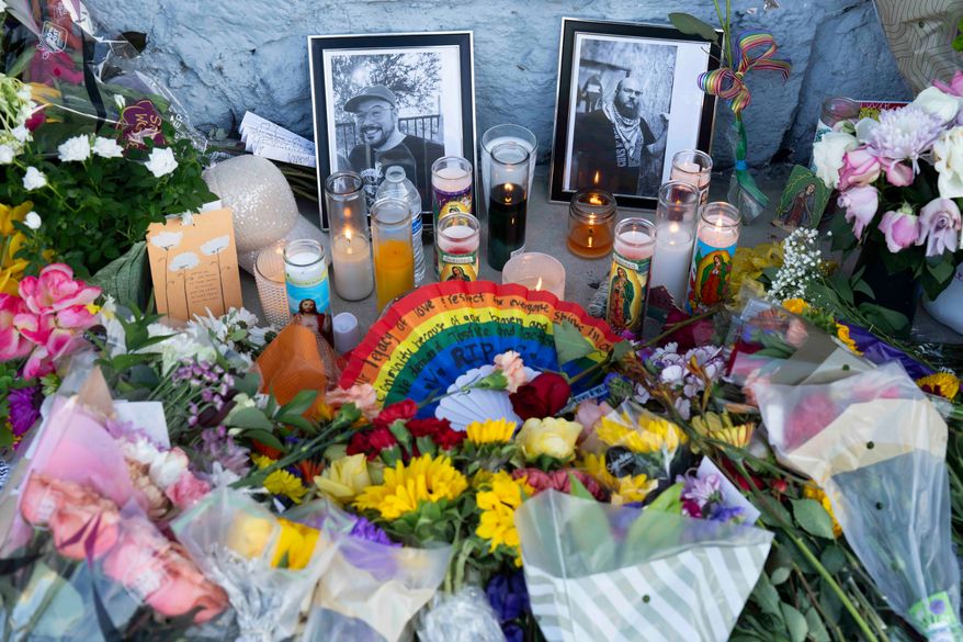 A growing memorial sits outside the Venture-N bar in Tucson, Ariz., Tuesday, Sept. 1, 2026, for Vincent Anthony Siquieros and Cameron Davis Capara, who were fatally shot in the parking lot of the gay bar shortly after midnight on Monday. (AP Photo/Rebecca Noble)
