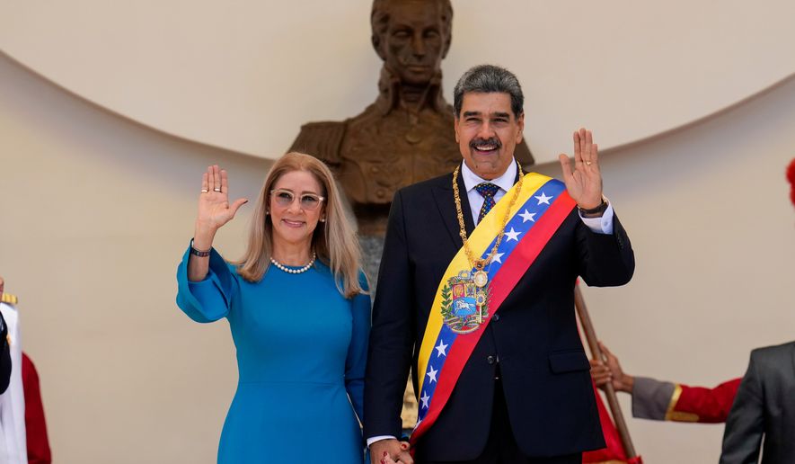 Venezuelan President Nicolas Maduro and his wife Cilia Flores wave after his swearing-in ceremony for a third term at the National Assembly in Caracas, Venezuela, on Jan. 10, 2025. (AP Photo/Ariana Cubillos, File)