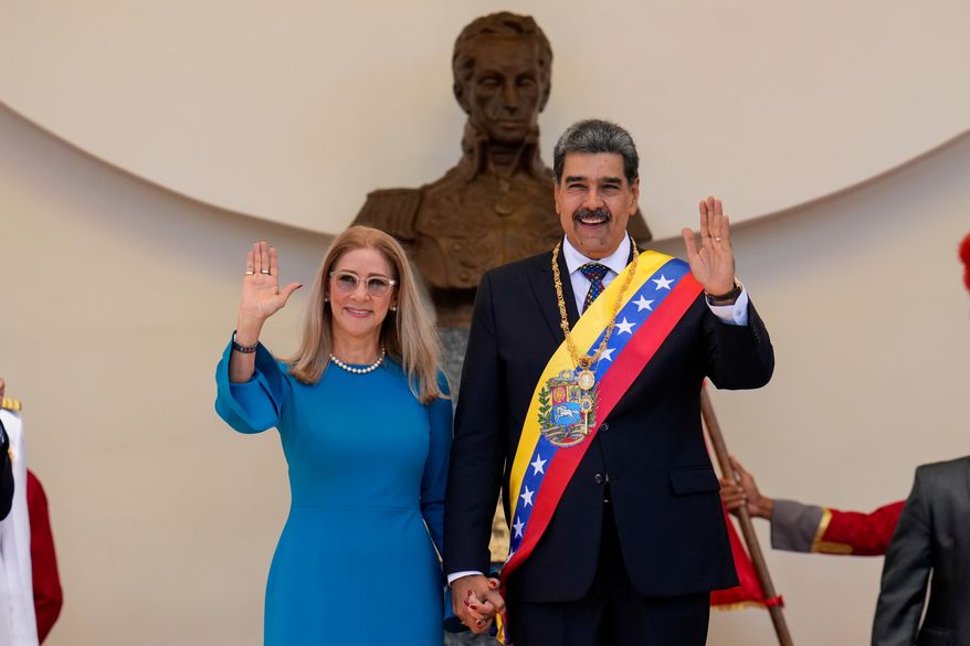 Venezuelan President Nicolas Maduro and his wife Cilia Flores wave after his swearing-in ceremony for a third term at the National Assembly in Caracas, Venezuela, on Jan. 10, 2025. (AP Photo/Ariana Cubillos, File)