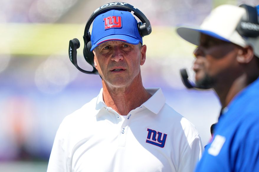 New York Giants head coach John Harbaugh walks along the sideline during the first half of a preseason NFL football game against the Minnesota Vikings Saturday, Aug. 15, 2026, in East Rutherford, N.J. (AP Photo/Yuki Iwamura)