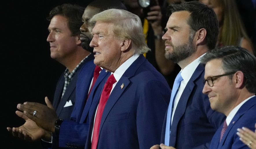 Republican presidential candidate former President Donald Trump, center, and Republican vice presidential candidate Sen. JD Vance, R-Ohio, second from the right, attend the first day of the Republican National Convention, Monday, July 15, 2024, in Milwaukee. Joining them are from l-r., Tucker Carlson, Rep. Byron Donalds, R-Fla., and House Speaker Mike Johnson of La. (AP Photo/J. Scott Applewhite)