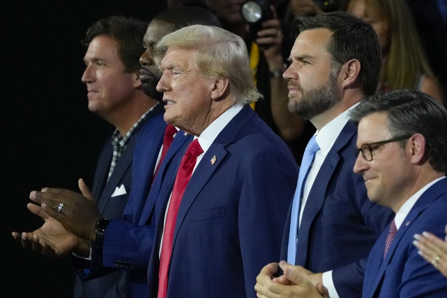 Republican presidential candidate former President Donald Trump, center, and Republican vice presidential candidate Sen. JD Vance, R-Ohio, second from the right, attend the first day of the Republican National Convention, Monday, July 15, 2024, in Milwaukee. Joining them are from l-r., Tucker Carlson, Rep. Byron Donalds, R-Fla., and House Speaker Mike Johnson of La. (AP Photo/J. Scott Applewhite)