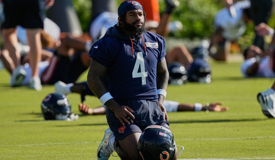 FILE - Chicago Bears running back D'Andre Swift warms up during practice at the team's NFL football training camp, Thursday, July 30, 2026, in Lake Forest, Ill. (AP Photo/Nam Y. Huh,File)