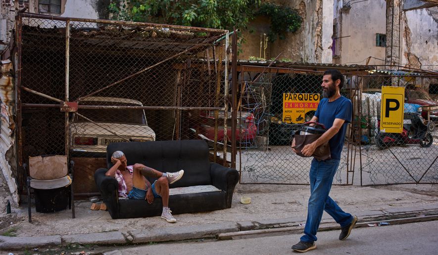 A man rests on a sofa on a street in Havana, Cuba, Thursday, Aug. 27, 2026. (AP Photo/Ramon Espinosa)