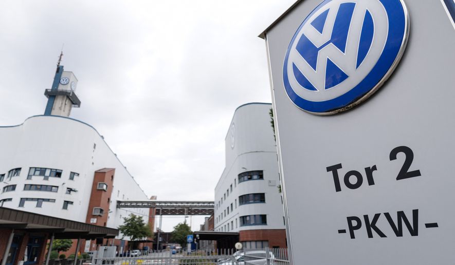 The VW logo in front of the Volkswagen plant in Osnabrueck, Germany, Wednesday, Aug. 26, 2026. (David Ebener/dpa via AP)