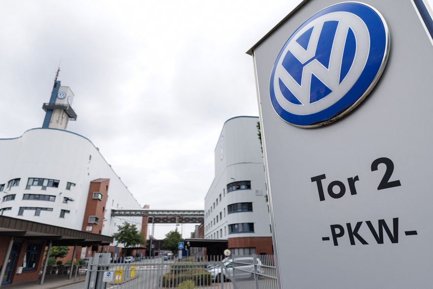 The VW logo in front of the Volkswagen plant in Osnabrueck, Germany, Wednesday, Aug. 26, 2026. (David Ebener/dpa via AP)