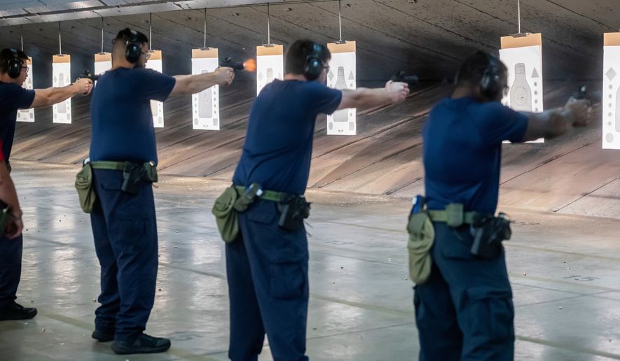 Immigration and Customs Enforcement (ICE) trainees practice shooting handguns at the indoor firing range at the Federal Law Enforcement Training Centers (FLETC) in Brunswick, Ga., Aug. 21, 2025. (AP Photo/Fran Ruchalski, File)
