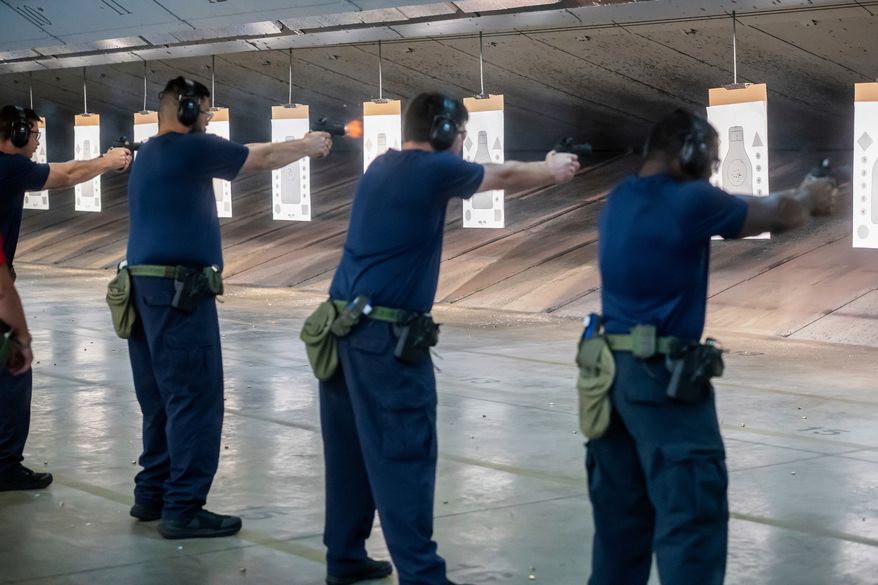 Immigration and Customs Enforcement (ICE) trainees practice shooting handguns at the indoor firing range at the Federal Law Enforcement Training Centers (FLETC) in Brunswick, Ga., Aug. 21, 2025. (AP Photo/Fran Ruchalski, File)