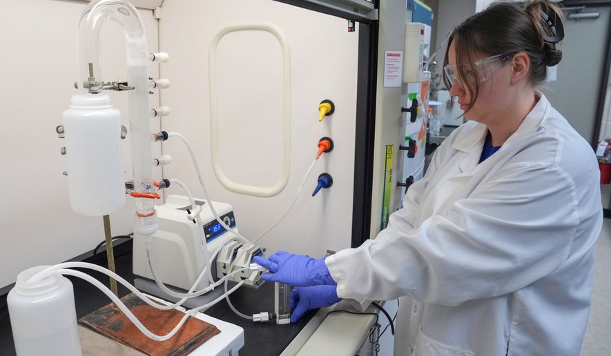 FILE - Stephanie Stoll starts a pump as part of an experiment studying the removal of PFAS from water samples, April 10, 2024, at a U.S. Environmental Protection Agency lab in Cincinnati. (AP Photo/Joshua A. Bickel, File)