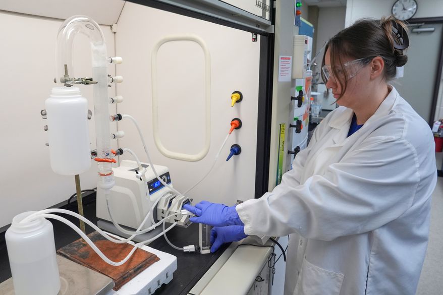 FILE - Stephanie Stoll starts a pump as part of an experiment studying the removal of PFAS from water samples, April 10, 2024, at a U.S. Environmental Protection Agency lab in Cincinnati. (AP Photo/Joshua A. Bickel, File)